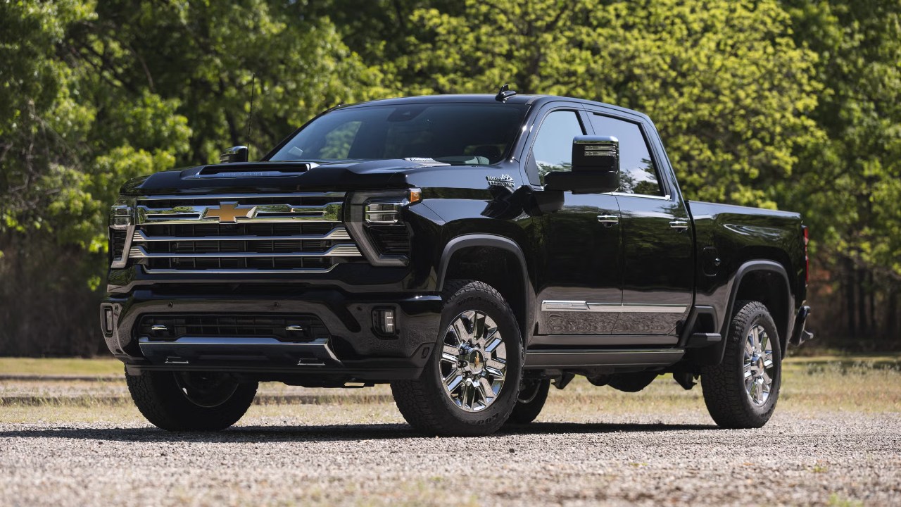 Chevrolet Silverado 2500HD parked on a gravel road surrounded by trees