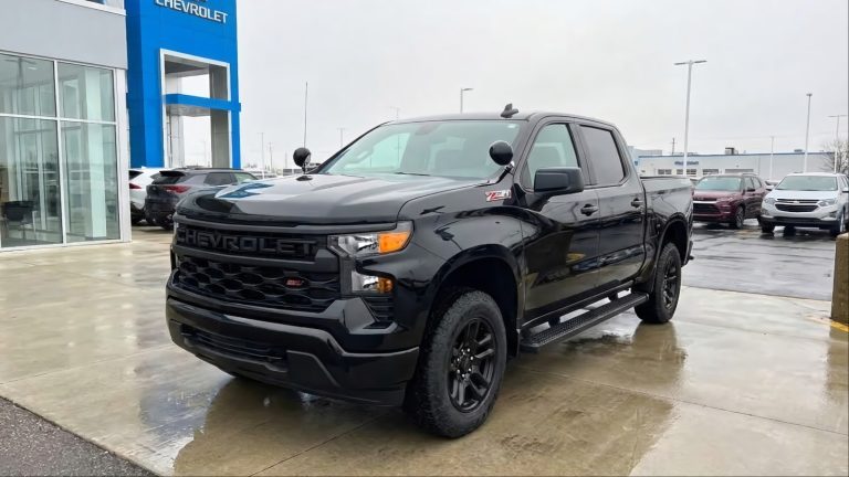 A Chevrolet Silverado Police is standing in front of Chevy Dealership