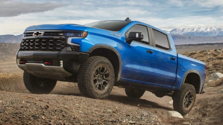 Chevrolet Silverado ZR2 tackling rugged terrain with mountains in the background