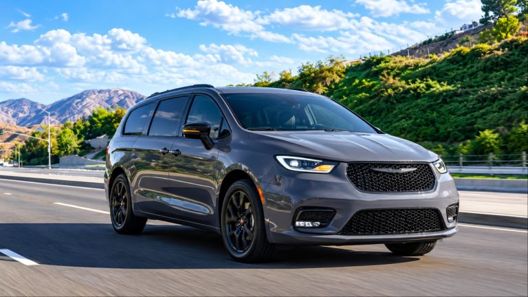 Chrysler Pacifica minivan driving on a scenic mountain highway