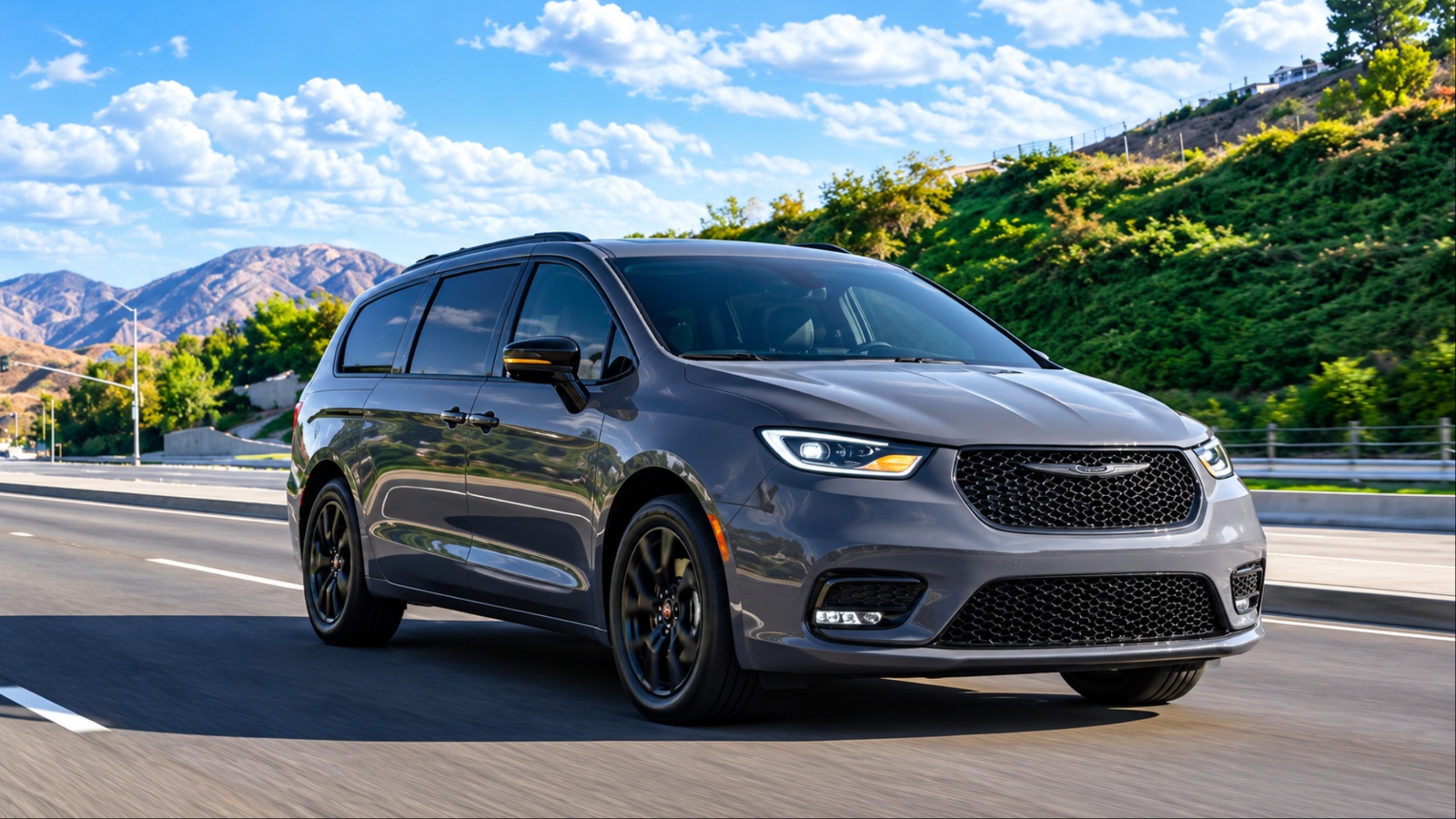 Chrysler Pacifica minivan driving on a scenic mountain highway