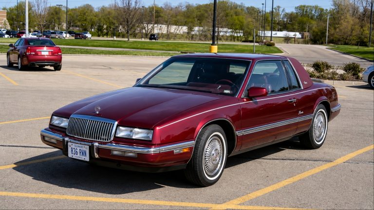 Classic Buick Riviera parked in a lot, showcasing its distinctive 1980s luxury styling