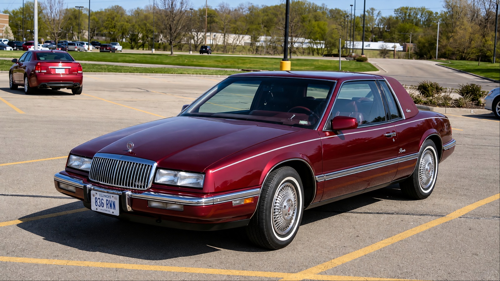 Classic Buick Riviera parked in a lot, showcasing its distinctive 1980s luxury styling