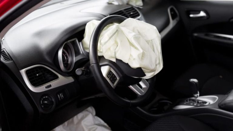 Deployed driver-side airbag inside a car following a collision