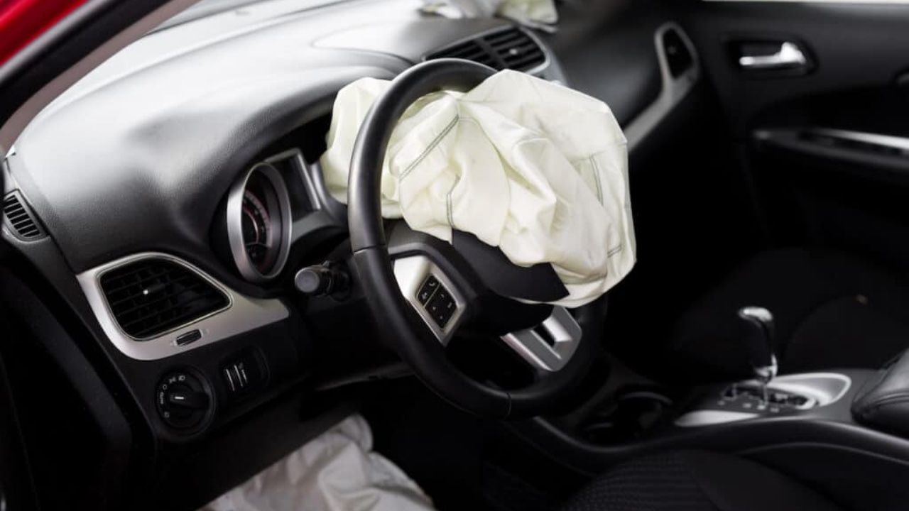Deployed driver-side airbag inside a car following a collision