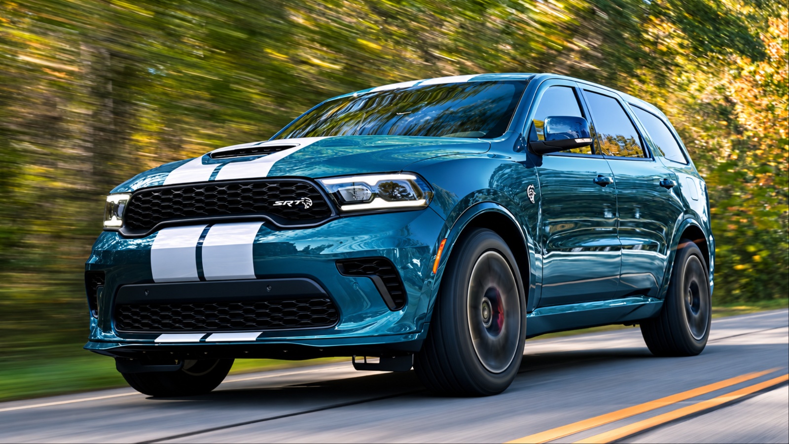 Dodge Durango SRT driving quickly along a tree-lined road