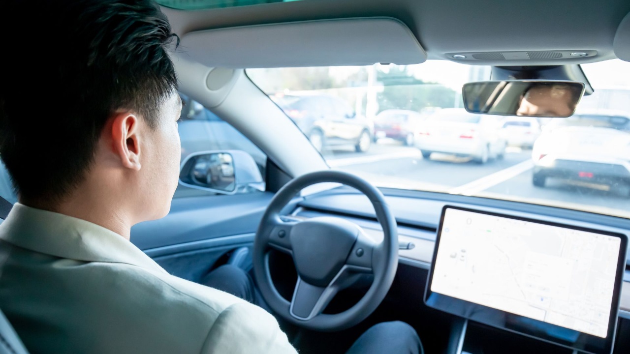 Driver navigating busy traffic while using the car’s touchscreen navigation system