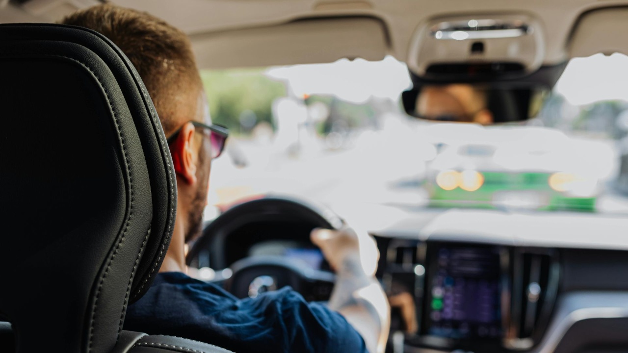 Driver navigating traffic while interacting with a vehicle’s connected dashboard