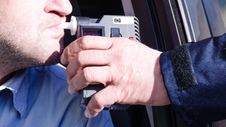 Driver undergoing a breathalyzer test for suspected impaired driving
