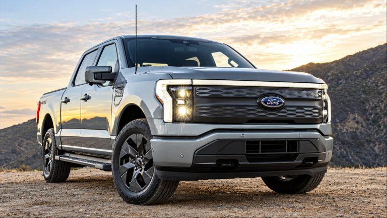 Ford F-150 pickup truck parked against a mountainous landscape under bright skies