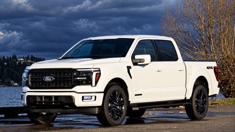Ford F-150 pickup parked on a wet road beneath dramatic storm clouds