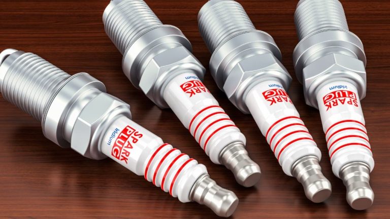 Four iridium spark plugs displayed together, highlighting their durable electrode design and construction