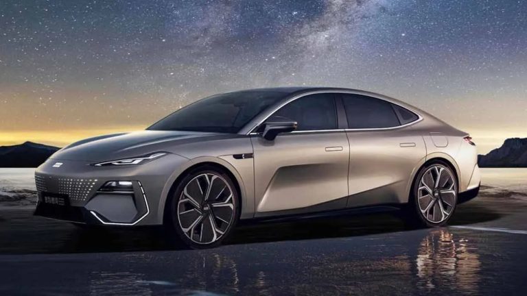 Geely electric sedan parked beside a lake beneath a dramatic star-filled night sky