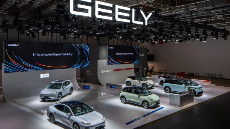 Geely showcase displays multiple electric vehicles inside a brightly lit exhibition hall