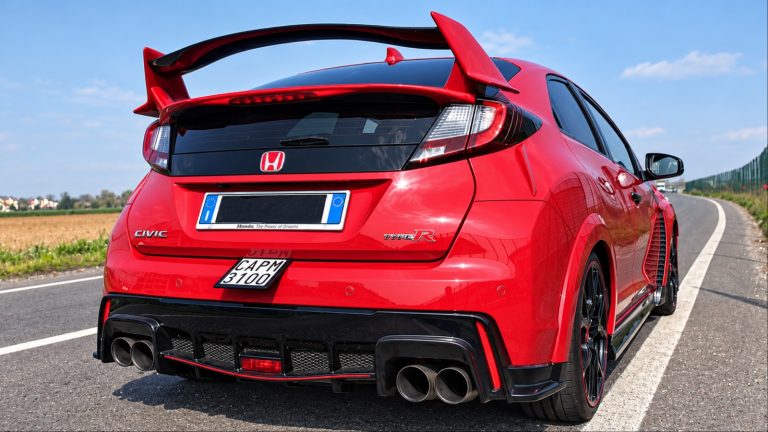 Bright red Honda Civic Type R hatchback on sunny road