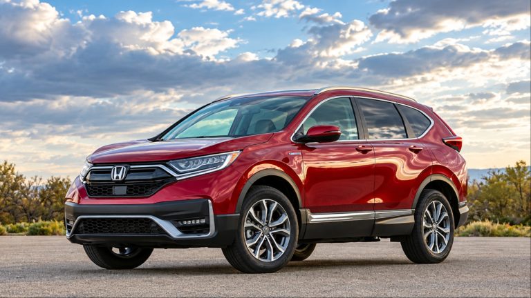 A red Honda CR-V sits outdoors beneath a dramatic cloudy sky
