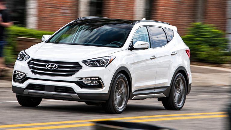 Hyundai Santa Fe Sport driving through a city street with motion blur