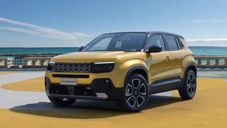Jeep Avenger SUV parked beside the sea on a sunny day