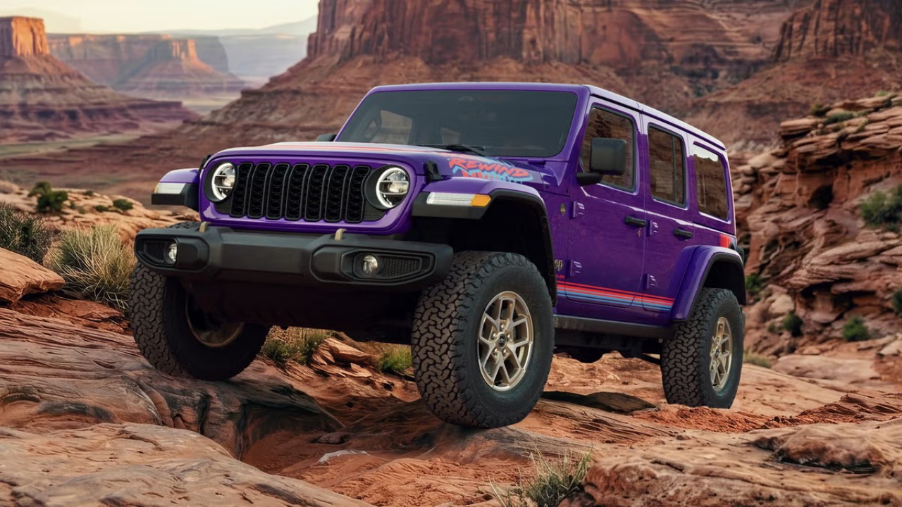 Jeep Wrangler climbing rocky terrain in a dramatic desert canyon landscape