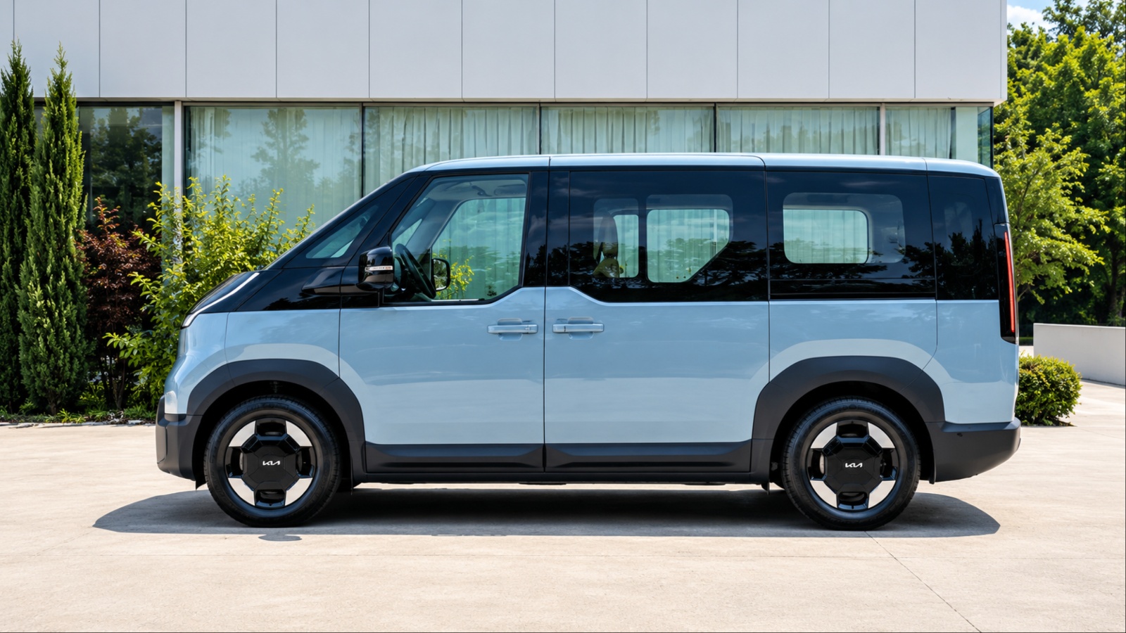 Kia PV7 electric van parked outside a modern building in daylight