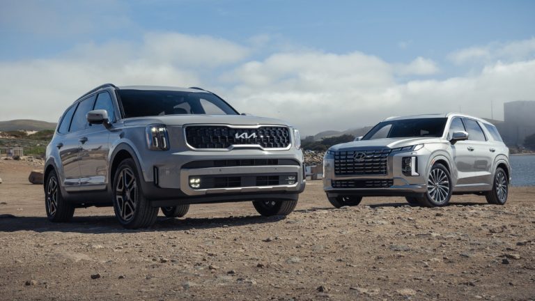 Kia Telluride and Hyundai Palisade parked together on rugged terrain