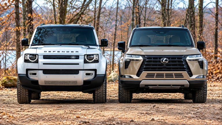 Land Rover Defender and Lexus GX parked side-by-side on woodland terrain