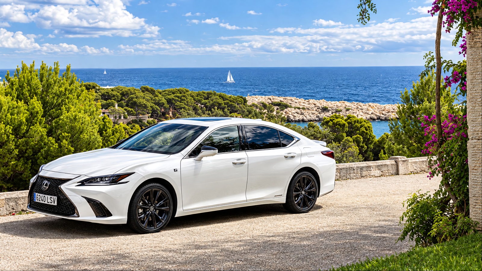 A spotless white Lexus ES 300h is standing on a rough road surrounded by greenery