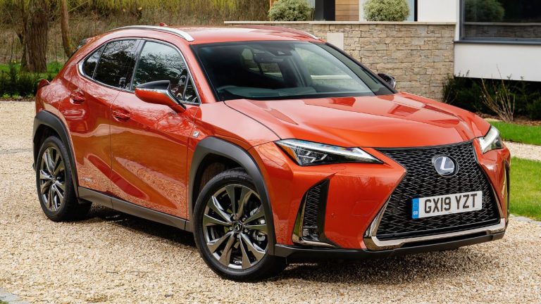 Lexus UX hybrid parked outside a modern home, showcasing its striking design