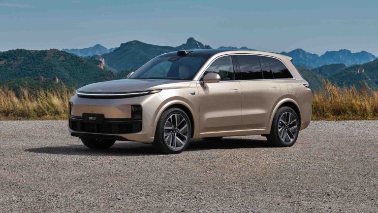 Li Auto L8 SUV parked against a dramatic mountain landscape