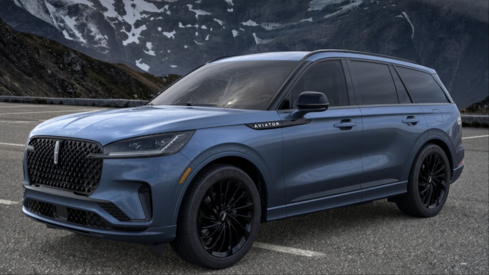 Lincoln Aviator parked on a mountain road surrounded by snow-covered peaks