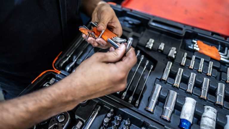 Mechanic selecting the right tool from a comprehensive automotive repair kit