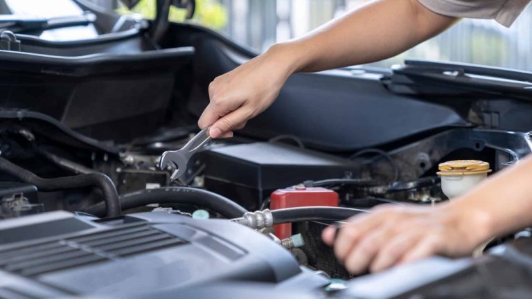 Mechanic working on a car engine during a routine maintenance check