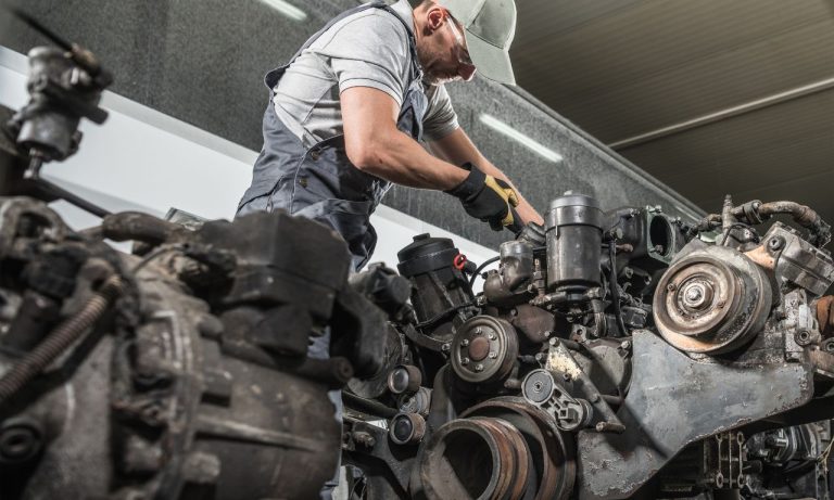 Mechanic working on a large diesel engine