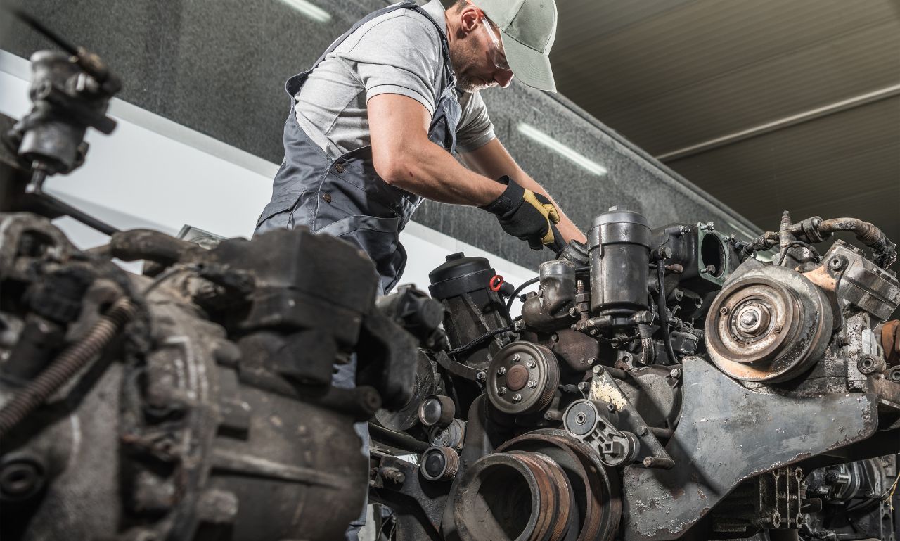 Mechanic working on a large diesel engine