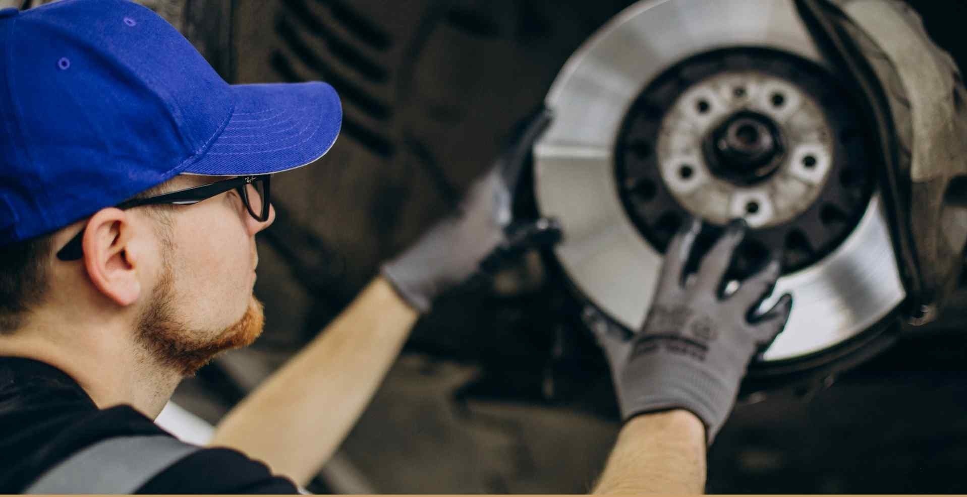 Mechanic working on a vehicle's brake system