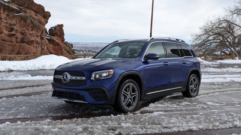 Mercedes-Benz GLB sits on an icy road beside snowy mountain scenery
