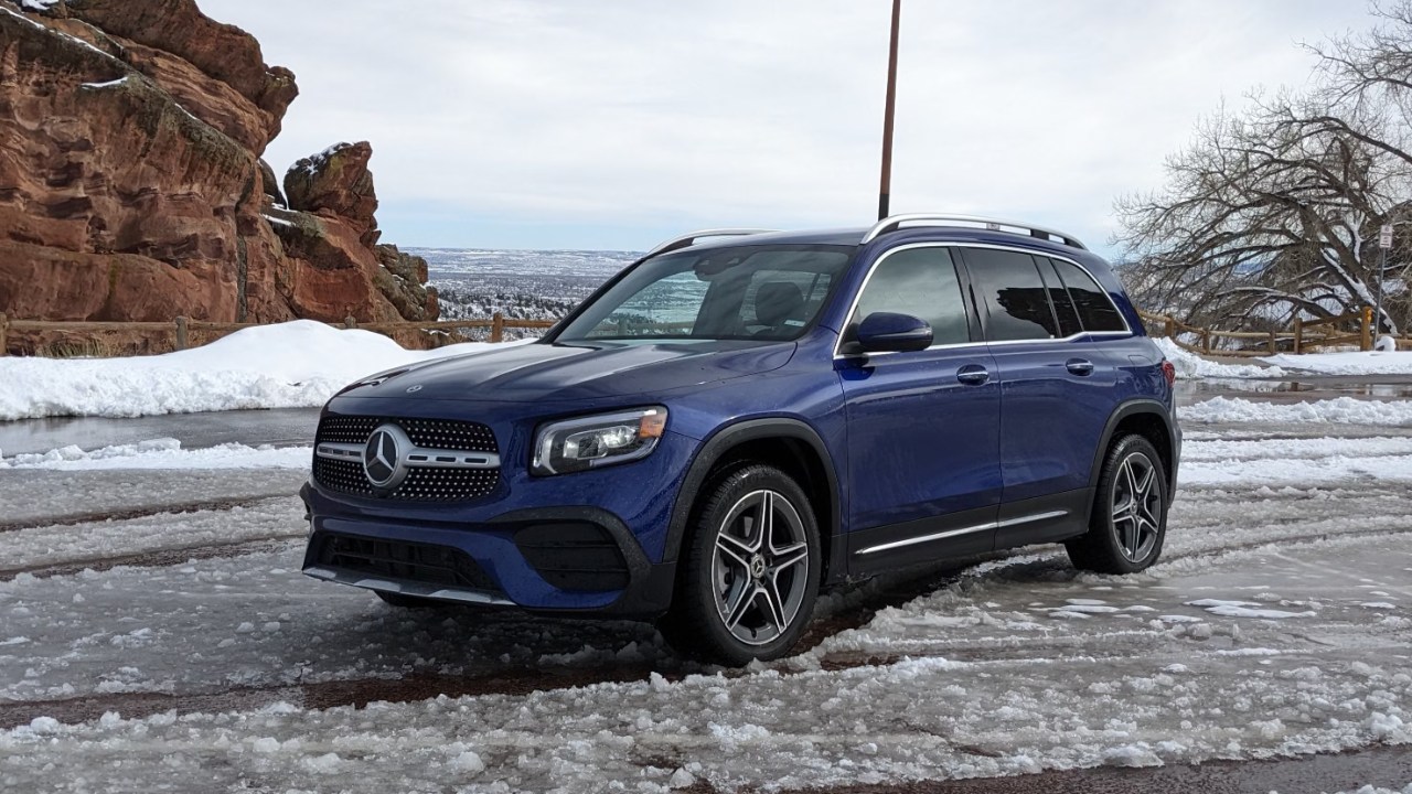 Mercedes-Benz GLB sits on an icy road beside snowy mountain scenery