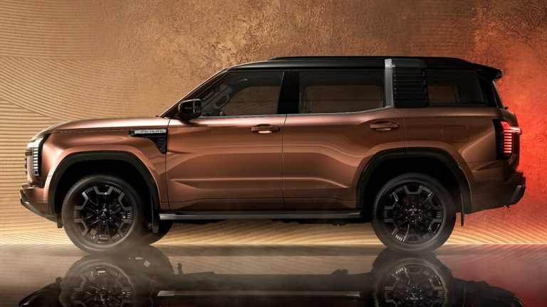 Mitsubishi Pajero SUV shown in side profile against a dramatic backdrop