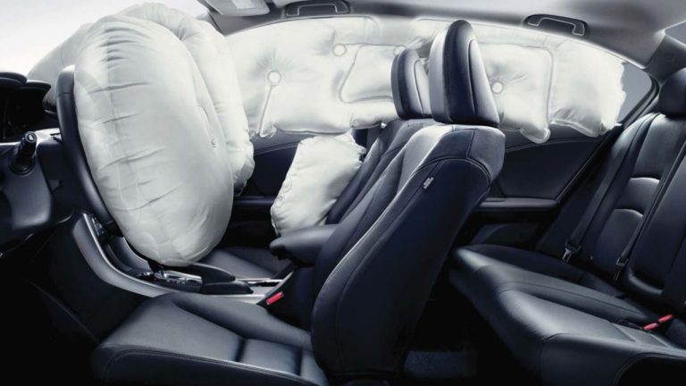 Multiple airbags are deployed throughout the vehicle interior after a collision