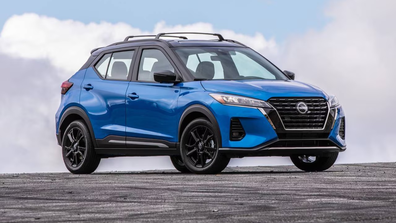 Nissan Kicks parked on an open roadway beneath a bright, cloudy sky