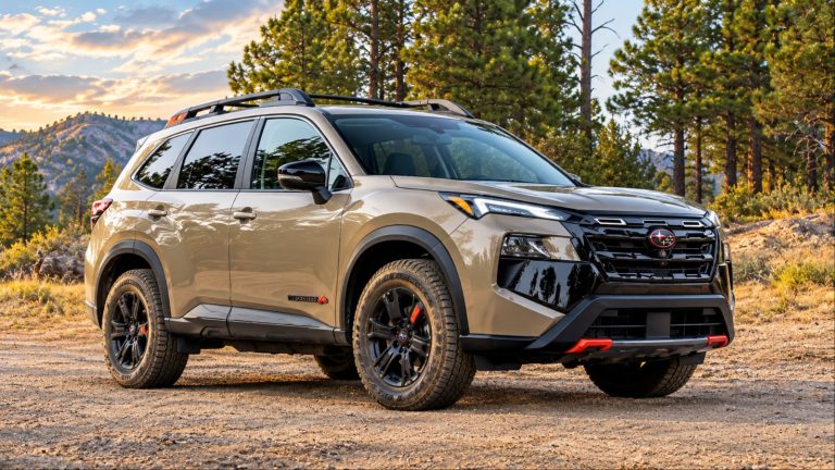 A Nissan Rogue Rock Creek sits on a rugged forest trail with all-terrain tires
