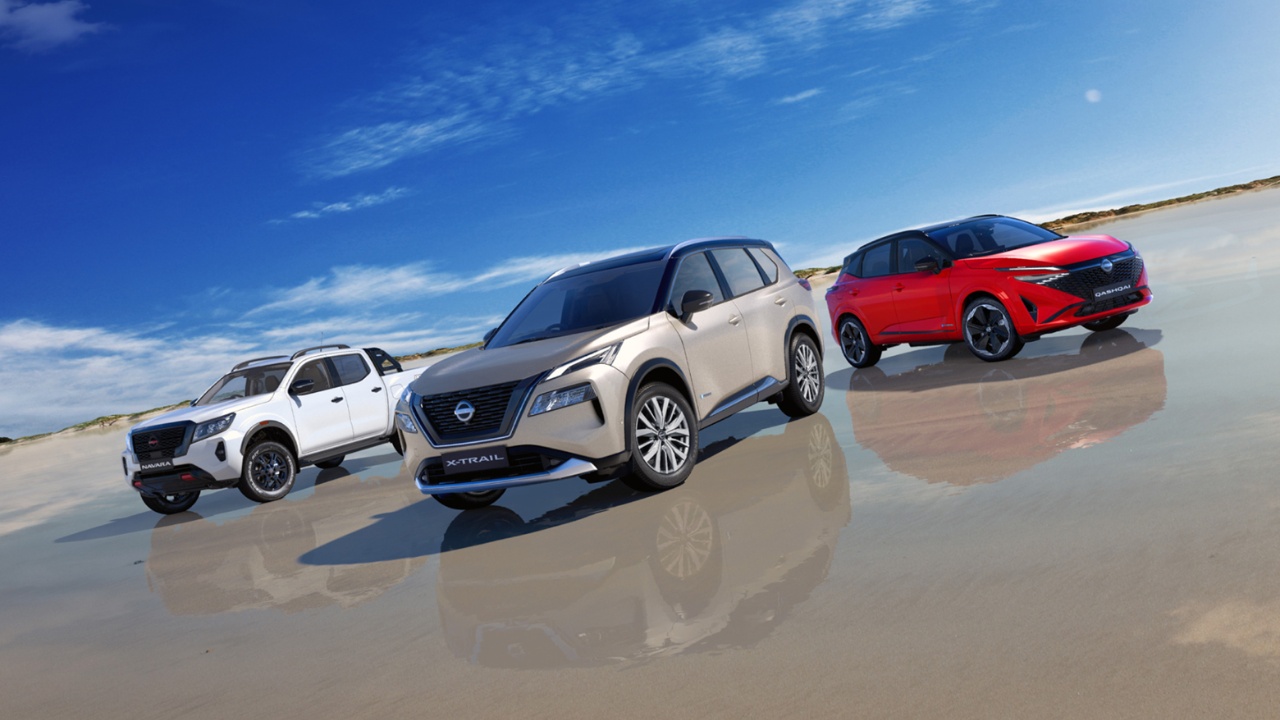 Nissan showcases three SUVs driving across a reflective landscape under blue skies