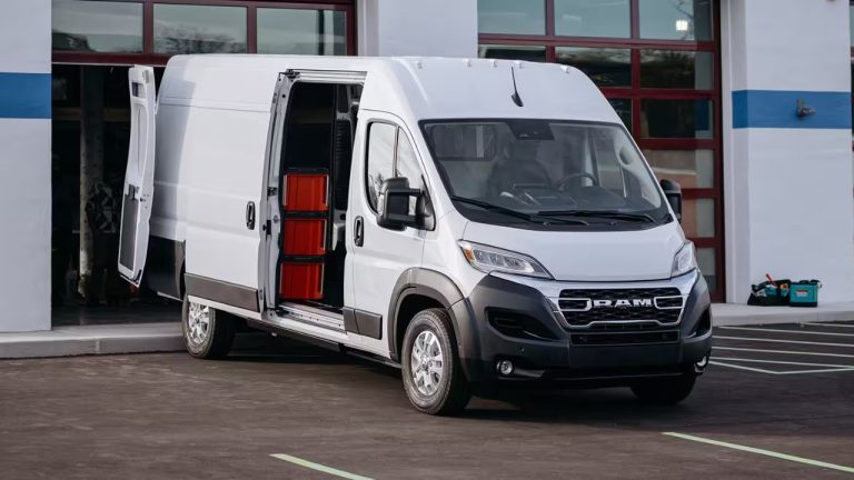 Ram ProMaster EV parked outside a commercial building with rear doors open