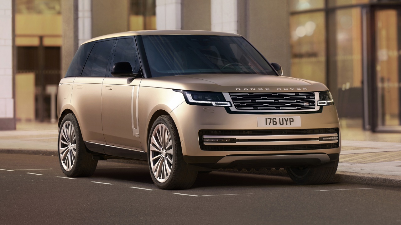 Range Rover luxury SUV parked on a city street beside modern buildings