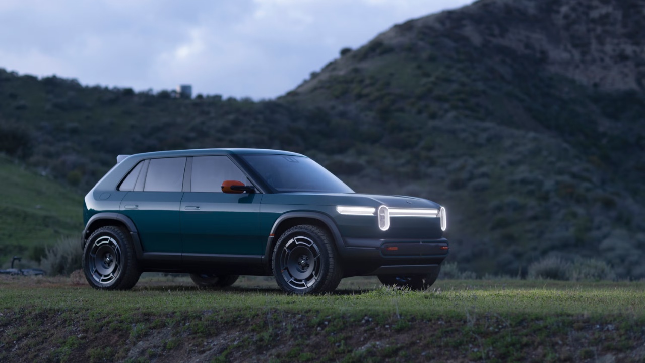 Rivian R3 electric SUV parked outdoors against a rugged mountain landscape