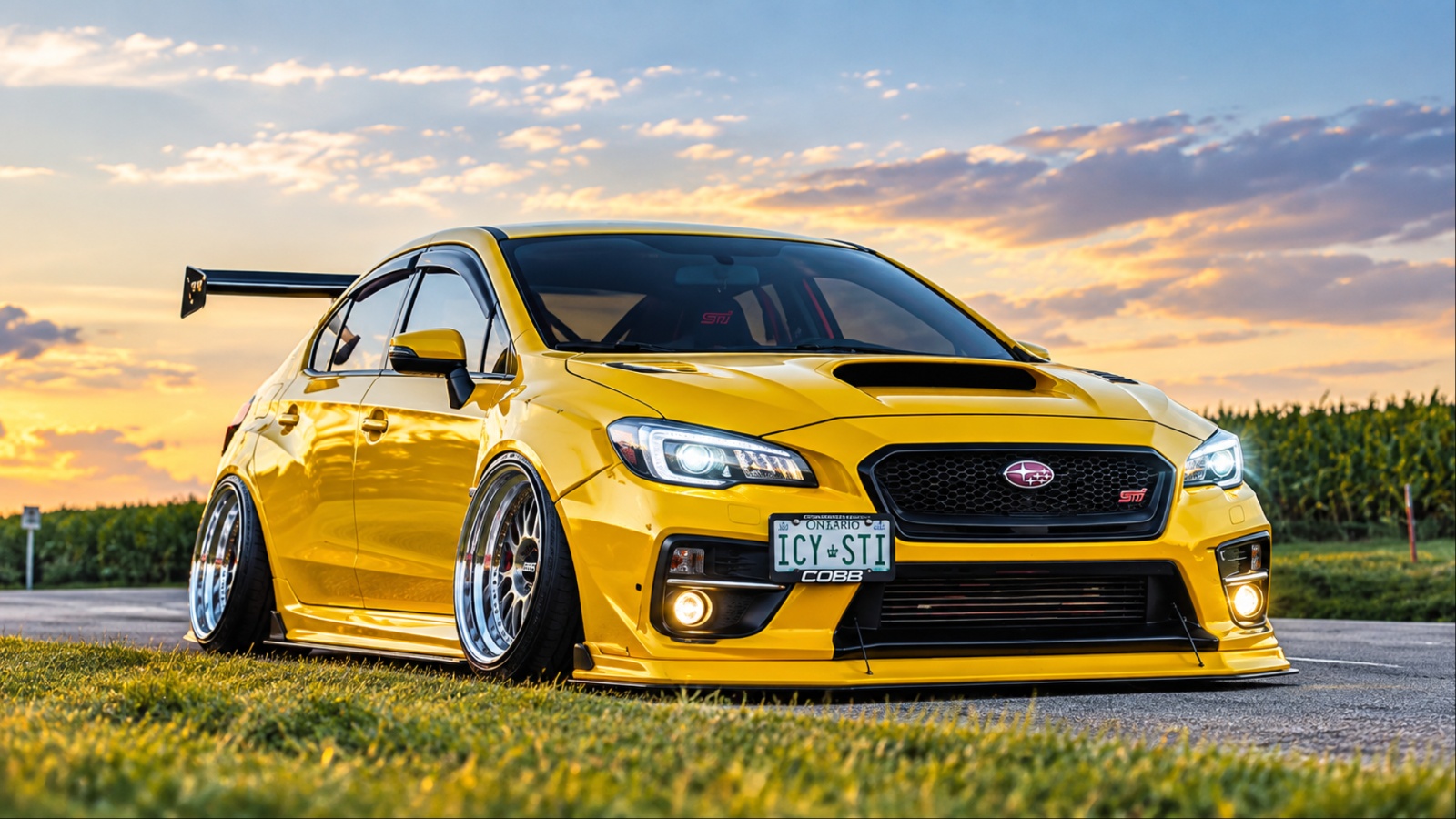 Modified Subaru WRX STI featuring an aggressive body kit, lowered stance, and oversized rear wing