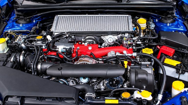 Close-up of Subaru WRX STI turbocharged boxer engine bay with red intake