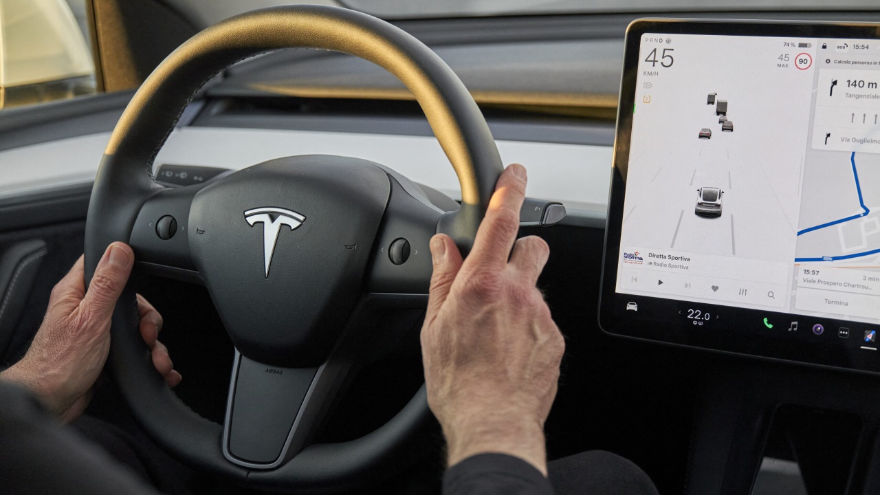 Tesla vehicle interior showing the steering wheel and central touchscreen display