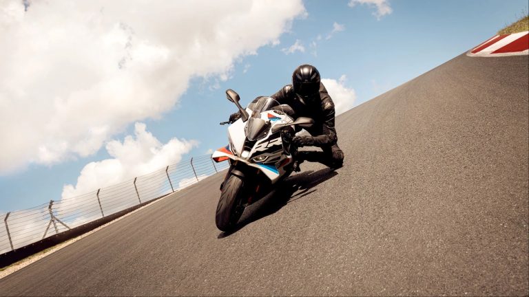 A motorbike driver is cruising on a highway