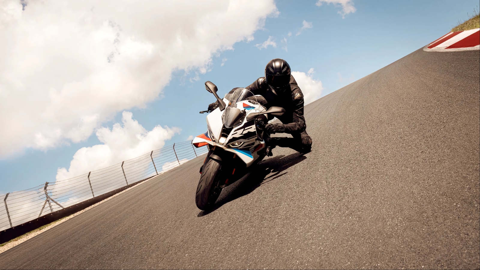 A motorbike driver is cruising on a highway